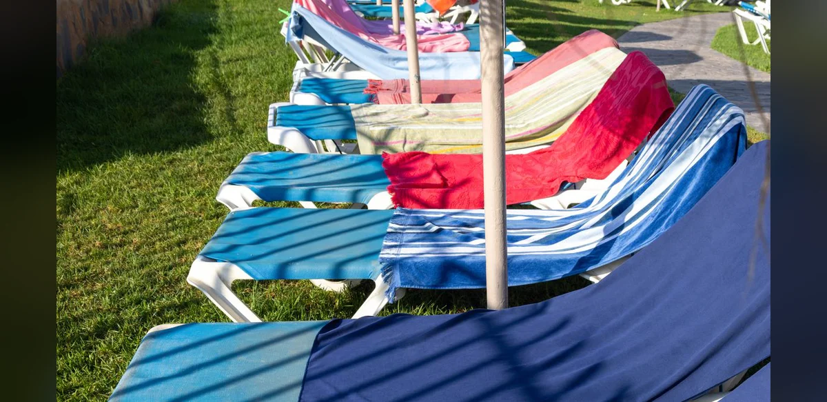 Tourist Documents Morning Competition for Pool Loungers at Spanish Resort Hotel